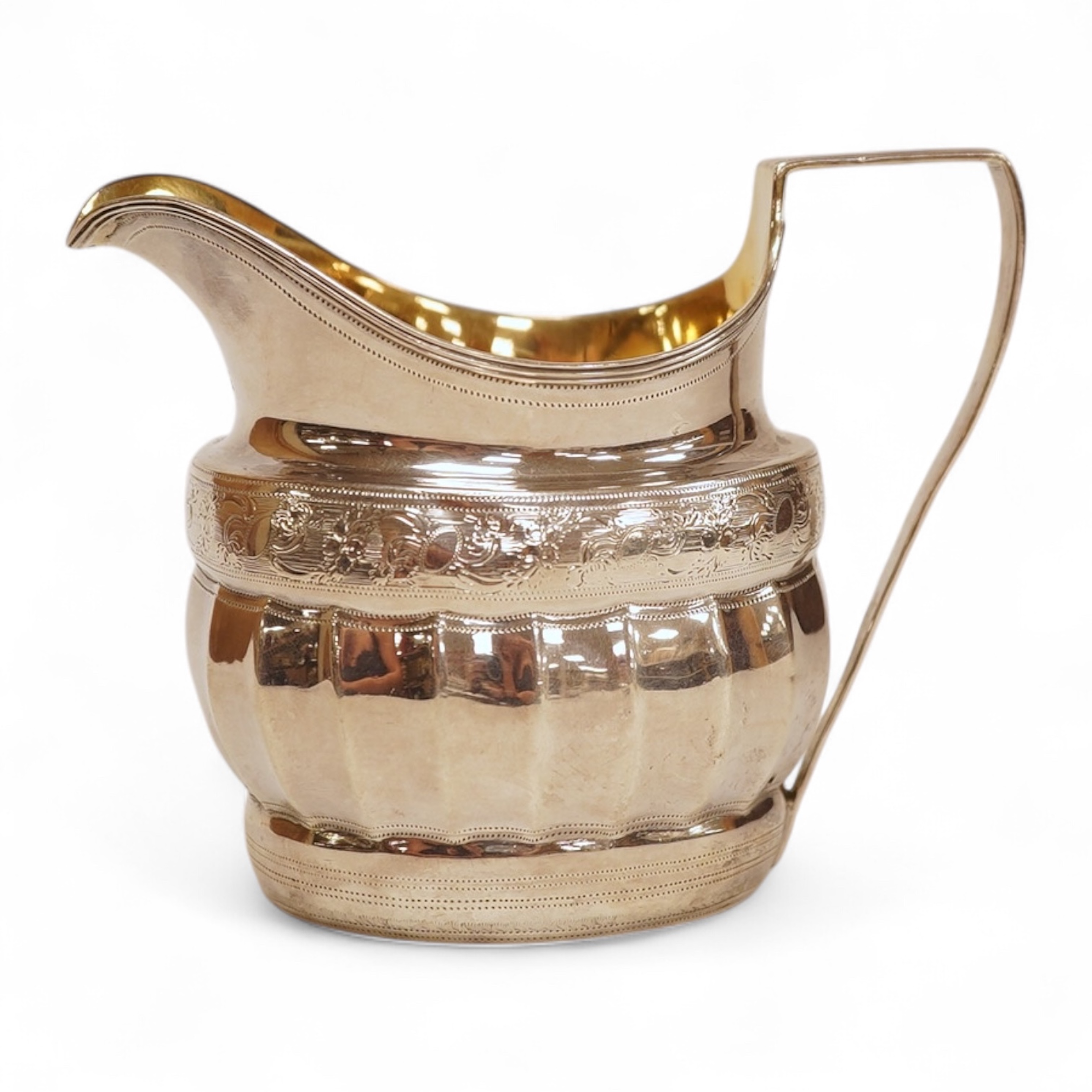 A George III engraved silver helmet shaped cream jug, with fluted body, Soloman Hougham?, London, 1800, height 97mm, 4.5oz (repair).